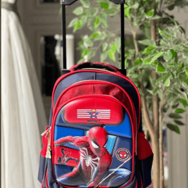 Red and navy blue rolling backpack with a extendable trolley handle, featuring a 3D embossed Spider-Man in a web-slinging action pose