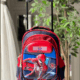 Red and navy blue rolling backpack with a extendable trolley handle, featuring a 3D embossed Spider-Man in a web-slinging action pose