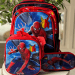 Red and black Spider-Man 3-piece set including a school backpack, insulated lunch tote, and zip-around pencil case with 3D graphics against a city skyline