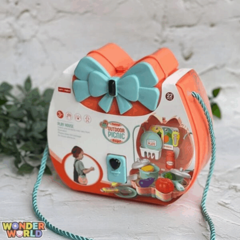 A structured hard-shell accessory case in warm coral pink with a large sculpted seafoam-blue bow clasp, styled with a twisted satin-sheen rope strap and showcasing illustrated picnic details