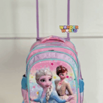 A rolling school backpack in soft pastel pink and lavender with vibrant aqua-blue zippers, showcasing a glossy 3D molded front panel of Queen Elsa and Princess Anna surrounded by colorful magical sparkles and floating snowflakes, attached to a pink telescoping handle
