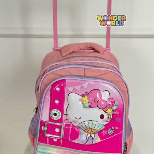 A rolling school backpack in soft pink and lavender, showcasing a glossy 3D molded front panel of a winking Hello Kitty holding a traditional folding fan and wearing a colorful flower crown, accented by a decorative oversized fuchsia buckle strap
