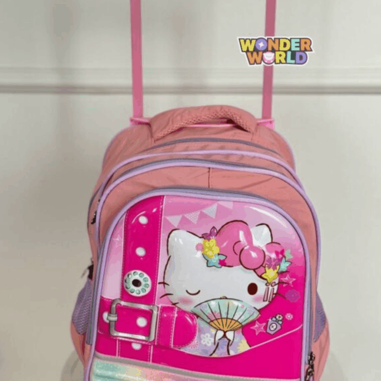 A rolling school backpack in soft pink and lavender, showcasing a glossy 3D molded front panel of a winking Hello Kitty holding a traditional folding fan and wearing a colorful flower crown, accented by a decorative oversized fuchsia buckle strap