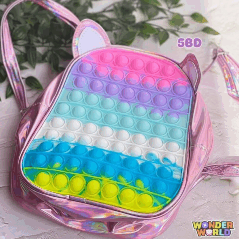 A round mini backpack featuring a metallic, holographic pink vinyl shell with attached matching unicorn ears and a front pop-it bubble panel in horizontal rows of pink, lavender, mint blue, white, royal blue, and neon yellow-green