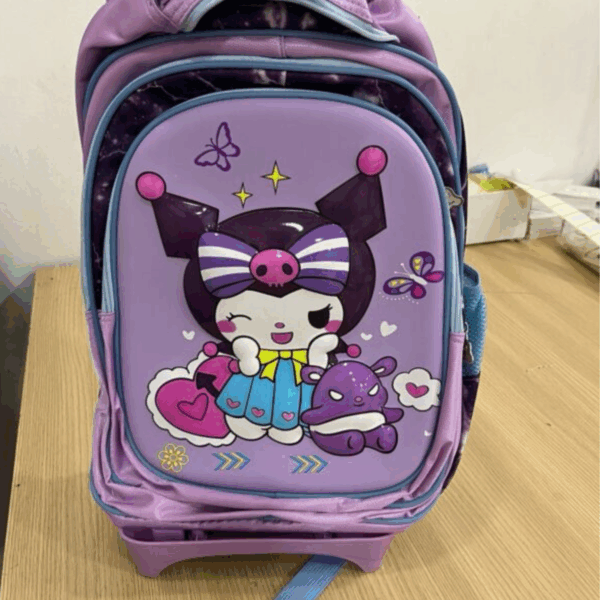 A close-up shot of the rolling bag from the file WW300A-600x600_2.jpeg, showing a lavender and deep purple trolley backpack with a molded 3D hard-shell front pocket of a winking Kuromi in a blue dress next to Baku, set against a background of stars and butterflies