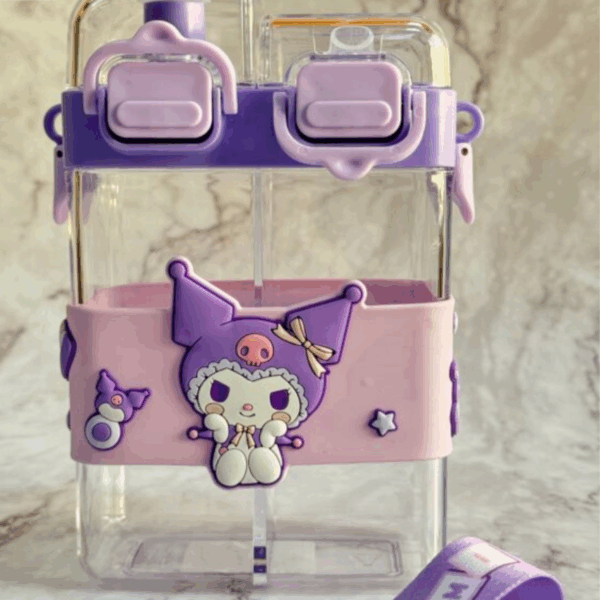 A modern square-shaped clear water bottle with split dual chambers, wrapped in a soft pastel pink protective silicone sleeve featuring a 3D sitting Kuromi wearing a gold bow on her purple hood next to a tiny purple Baku, topped by a lavender-and-purple cap with dual independent push-button locks