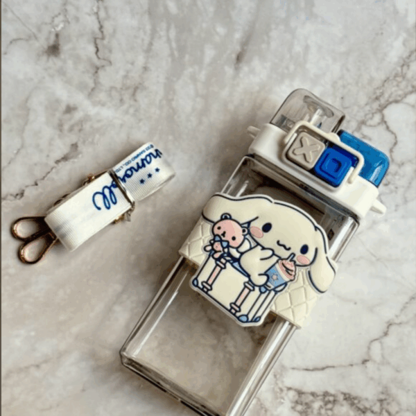 Clear square-shaped water bottle with a cream silicone sleeve featuring Cinnamoroll enjoying a cold drink, paired with a matching printed shoulder strap