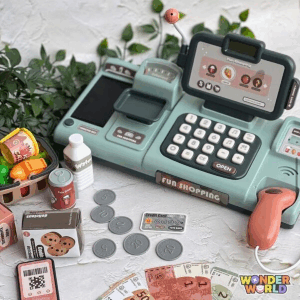 A high-end interactive toy checkout terminal in soft sage green, featuring a mock smart display screen, cream-colored buttons, and a warm terracotta barcode scanner, displayed alongside play money, a miniature credit card, and tiny grocery replicas