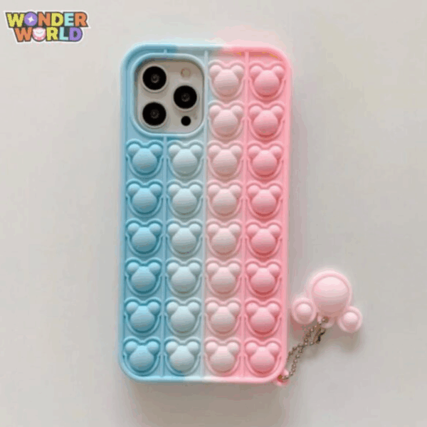 A close-up display of a whimsical silicone phone case split vertically down the middle in soft pastel sky blue and sweet blossom pink, featuring rows of responsive pop-it bubbles sculpted into adorable miniature mouse head silhouettes, complete with a matching pink mouse-ear pop-it charm attached by a silver ball chain