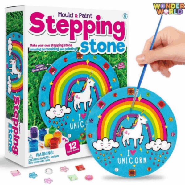A round hands-on plaster casting and painting set showing a painted unicorn stepping stone featuring a bright rainbow, smiling clouds with colorful raindrops, and shimmering rhinestone jewels, displayed with rich paint pots, sparkling gems, and a fine paintbrush