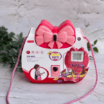 A structured hard-shell vanity case in vibrant fuchsia and pastel rose pink, showcasing an oversized layered pink bow clasp and a candy-stripe twisted shoulder strap, shown ready to pop open into a miniature pretend beauty salon