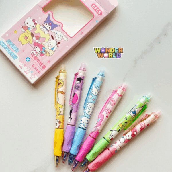 A fan-like display of six colorful retractable Sanrio gel pens resting on a light marble surface next to their pastel pink "Sanrio Community" display box, showcasing individual character-themed designs for Pompompurin in bright yellow, Kuromi in soft purple, Cinnamoroll in pastel blue, My Melody in rose pink, Pochacco in lime green, and Hello Kitty in coral pink, each styled with color-coordinated comfort grips and friction-eraser tops
