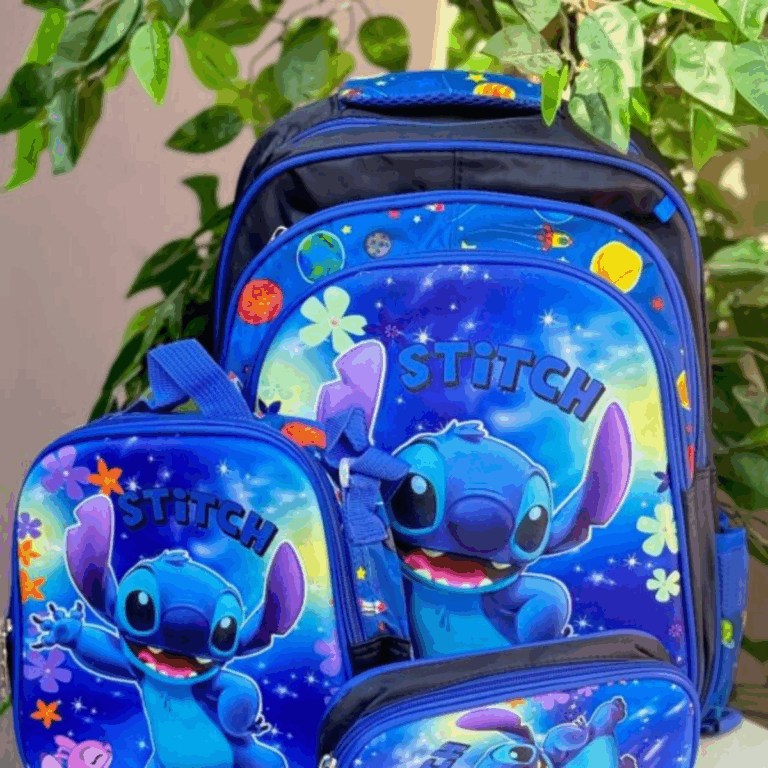 A three-piece school and travel set in royal blue and black, featuring a backpack, a matching lunch bag, and a pencil case decorated with a cosmic graphic of Stitch waving amongst colorful planets, stars, and retro tropical flowers