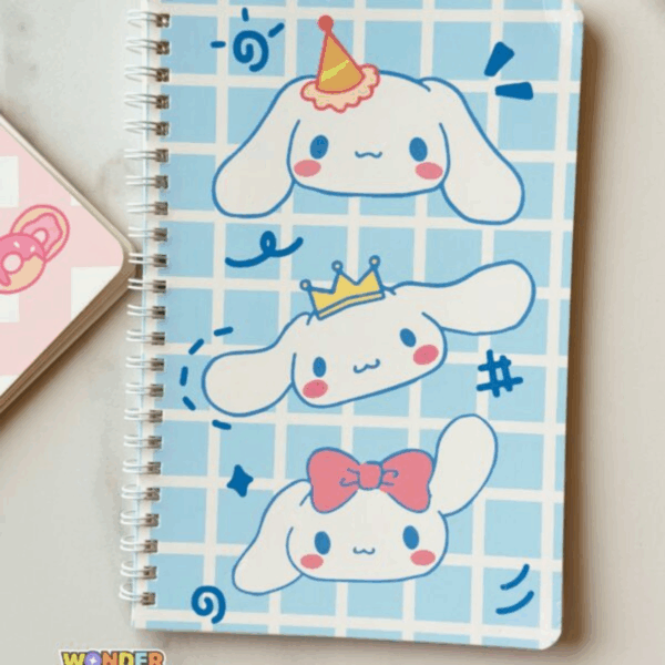 A light blue grid-patterned spiral notebook featuring three cute illustrations of Cinnamoroll stacked vertically, each wearing a different accessory: a party hat, a golden crown, and a pink bow