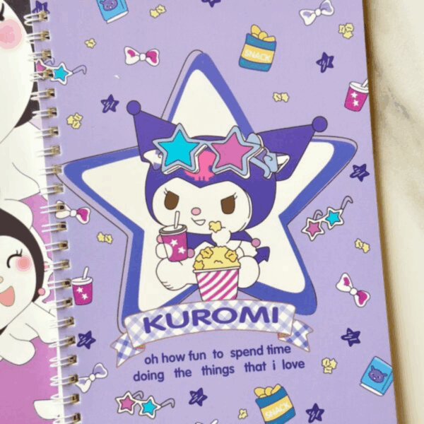 A purple spiral notebook featuring Kuromi wearing star-shaped sunglasses while sitting inside a large star emblem, eating popcorn and holding a soda drink. The background is patterned with tiny stars, snack bags, and bows, with a quote at the bottom