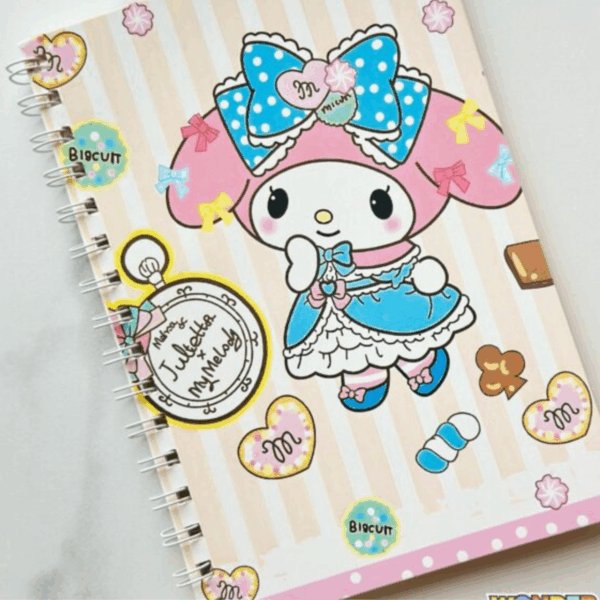 A wire-bound notebook featuring a beige and cream vertical striped cover with My Melody dressed in a blue lolita-style dress and a large blue polka-dot bow, surrounded by a vintage pocket watch illustration, heart-shaped cookies, and chocolate pieces